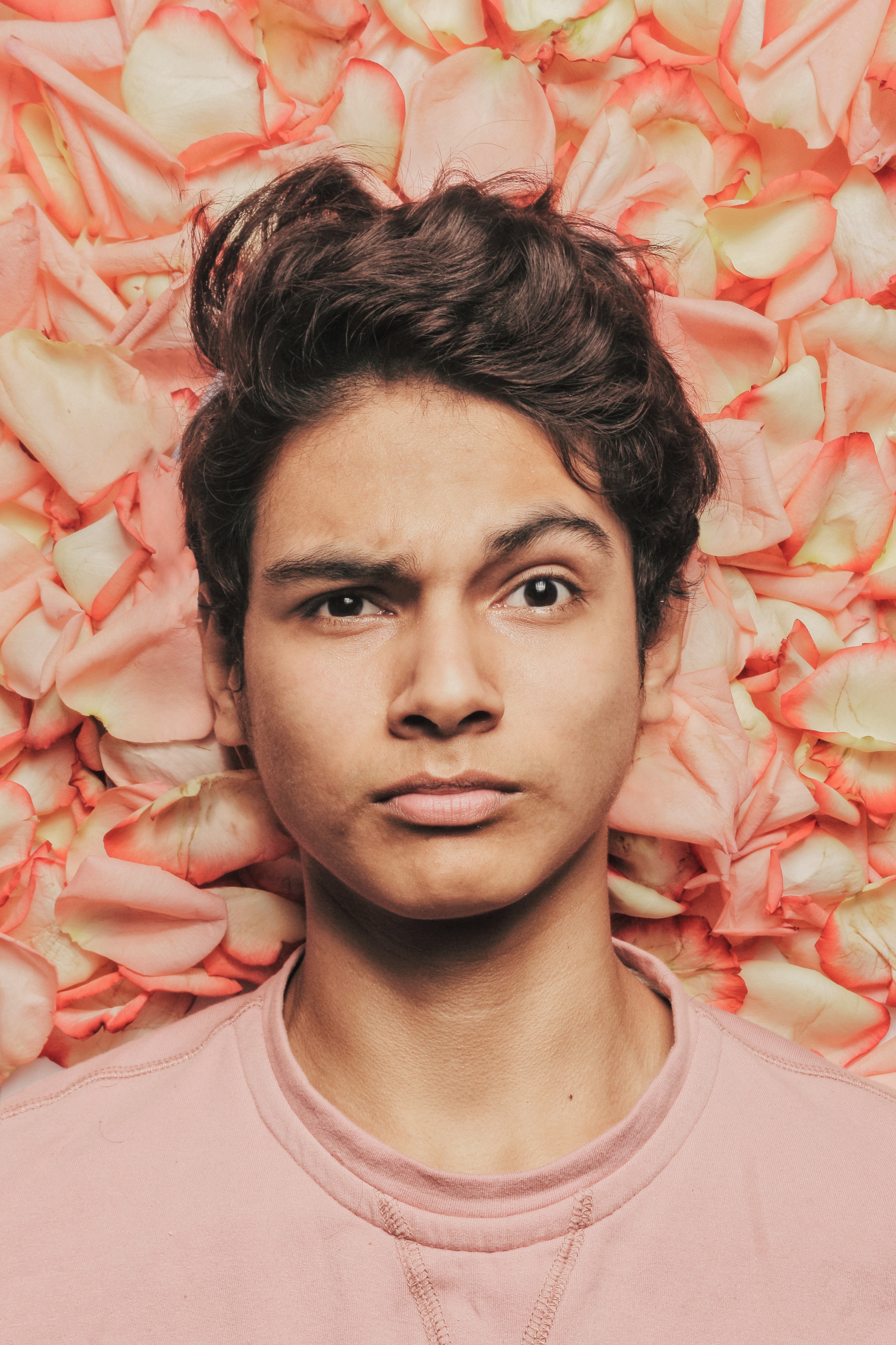 Questioning man against flower petals.